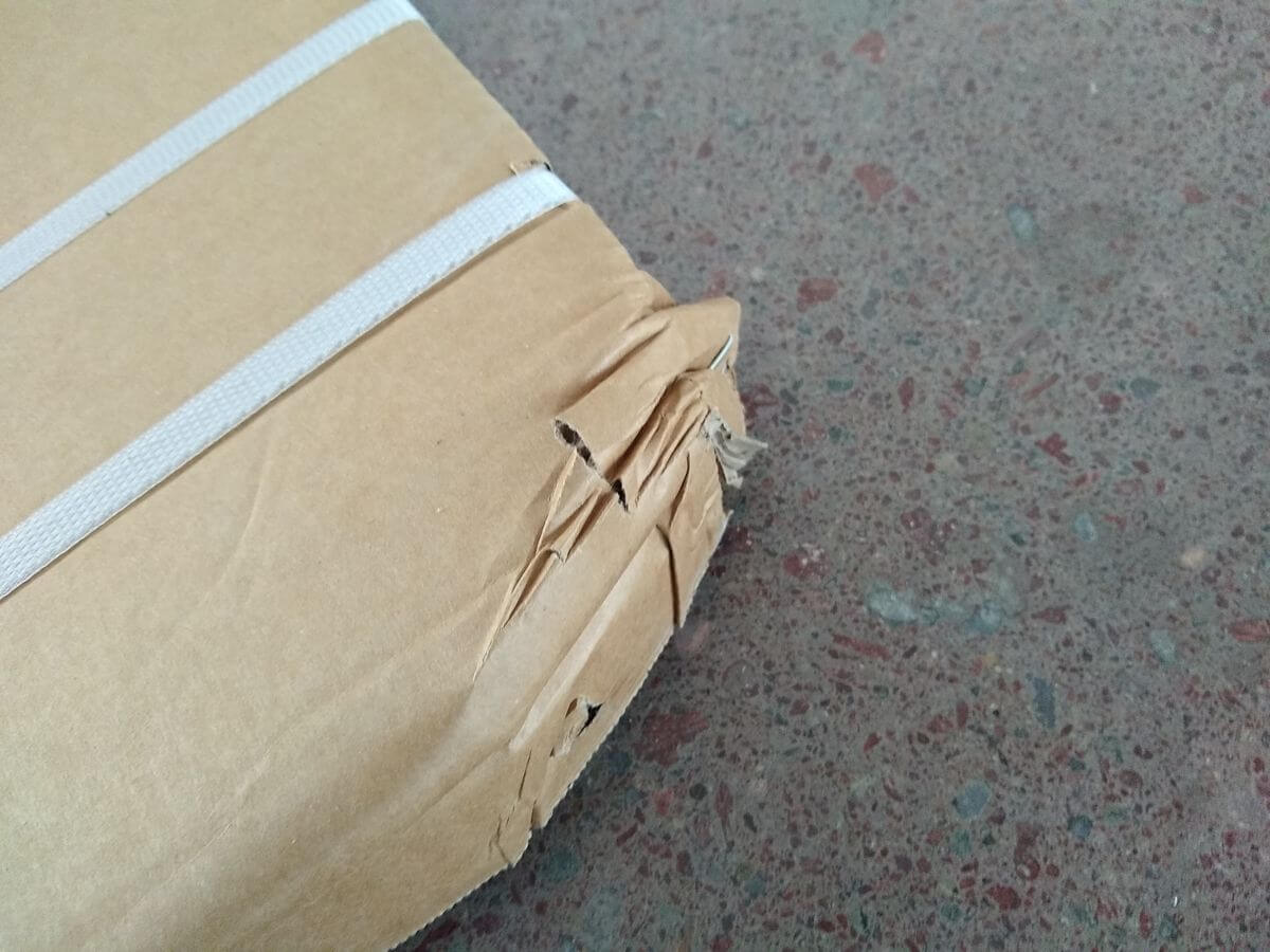 Carton after drop test - damage visible on KD fence packaging